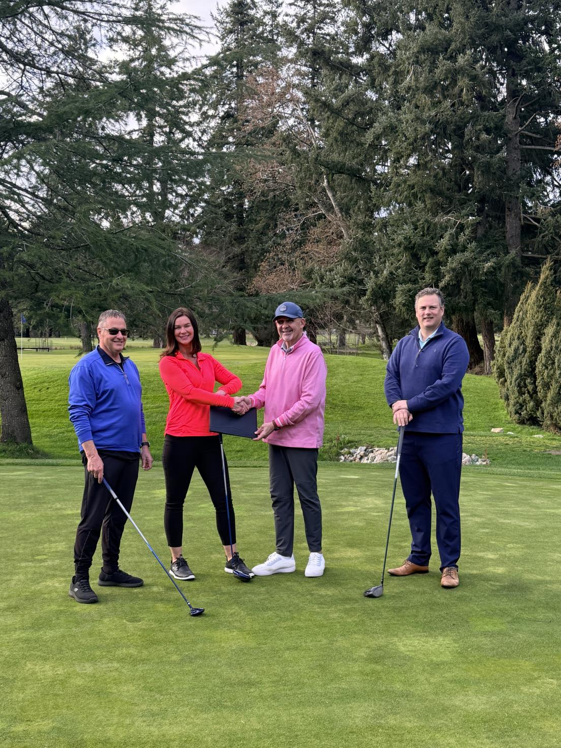 Mayor shakes hand with Comox Golf Club President with other members of Council
